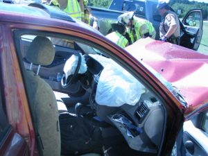 Ambulance staff renders aid at an accident. Airbags deployed. 